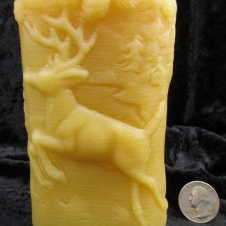 deer on one side of beeswax candle