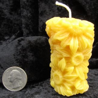 beeswax candle in a pillar of flowers